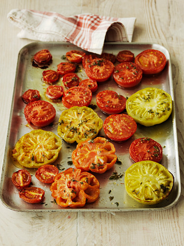 Selection of roast tomatoes on a baking tray