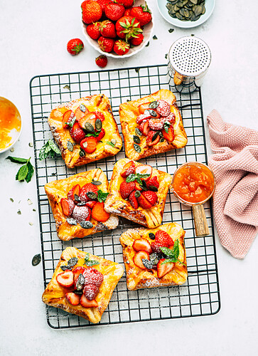 Danish puff pastry with strawberries on a cooling rack