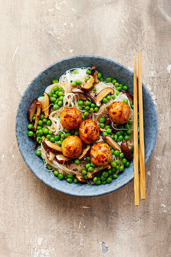 Rice noodle bowl with vegetable balls, peas and shiitake mushrooms