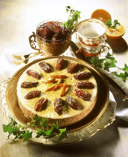 Carrot & date cake on cake plate garnished with dates
