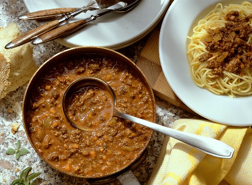 Bolognese sauce in pan and on spaghetti