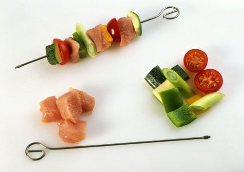Making turkey, courgette and tomato kebabs