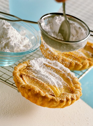 Apple and marzipan tarts with icing sugar