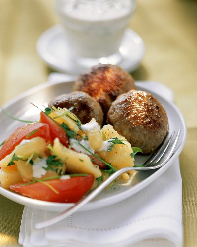 Potato salad with herbs, with meatballs