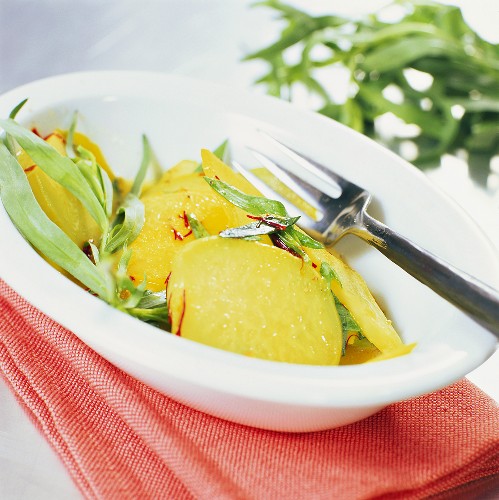 Kohlrabi with saffron and fresh tarragon in deep plate