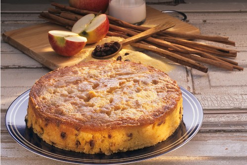 Cornmeal apple cake on plate in front of ingredients