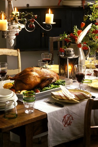 Laid table with roast Martinmas goose and red wine