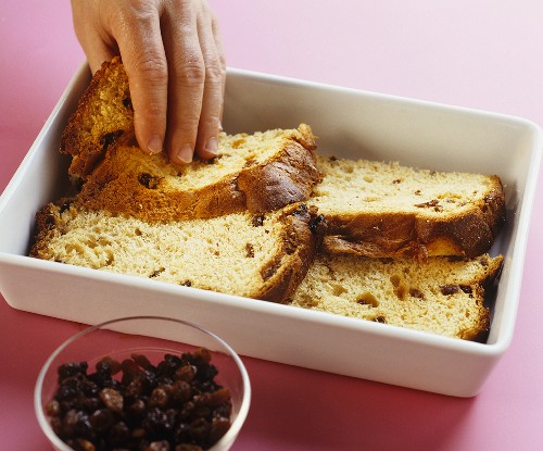 Laying panettone slices in baking dish