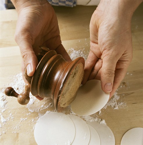 Making coconut macaroons (putting coconut mixture on wafers)