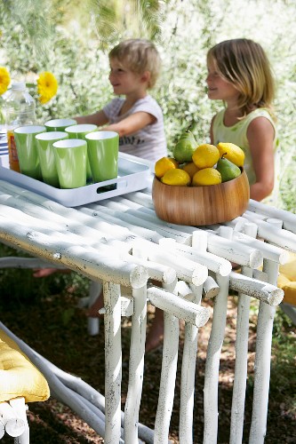 Children sitting at set table in garden