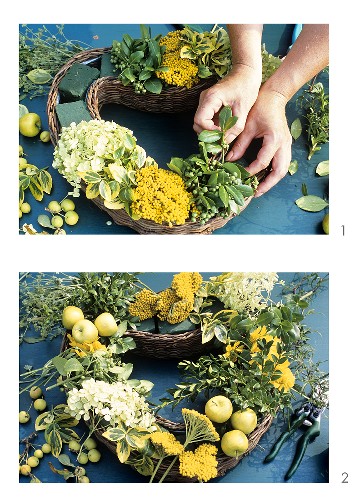 Filling heart-shaped willow container with late summer flowers