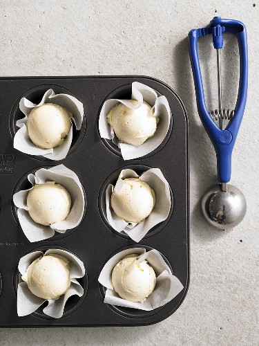 Orange sorbet in a paper-lined muffin tin
