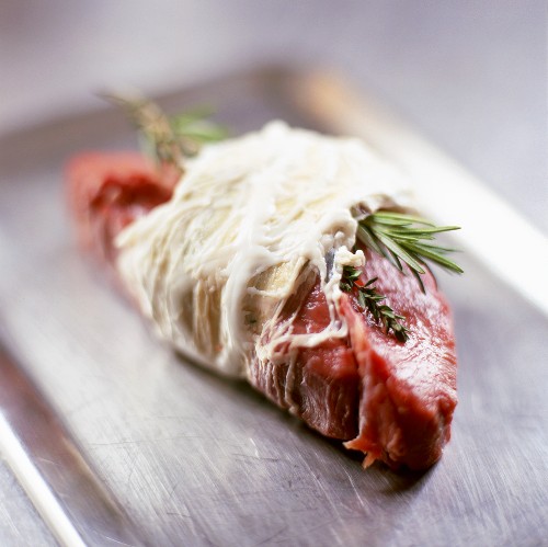 Wild board cutlet in pork caul with rosemary