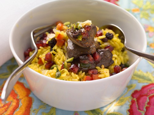 Exotic rice salad with pomegranate seeds and fried chicken liver