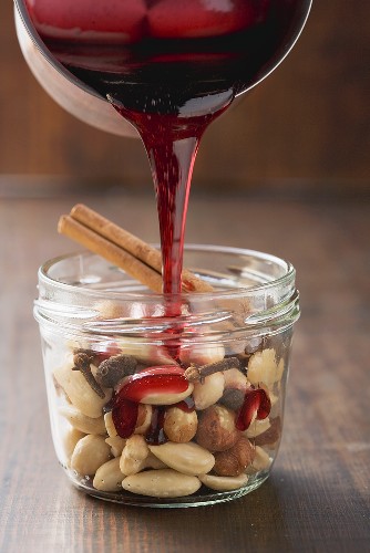 Red wine syrup being poured over nuts
