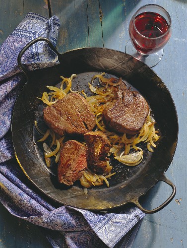 Steak with Onions in a Pan