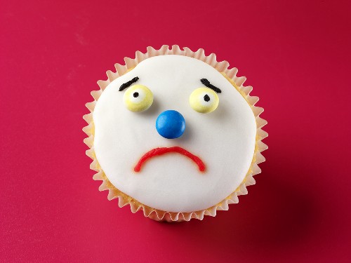 Cupcake with a sad face License Images 443885 StockFood