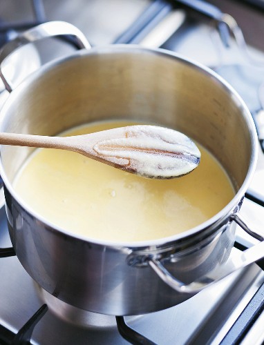 Making vanilla ice cream: adding the vanilla creme to the egg while stirring constantly