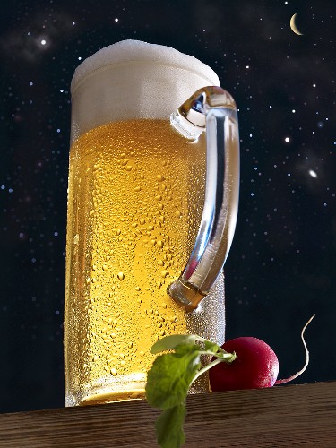 Larger in a glass tankard and a radish against a starry sky