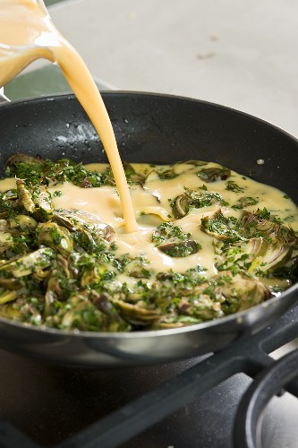 Artichoke omelette being prepared