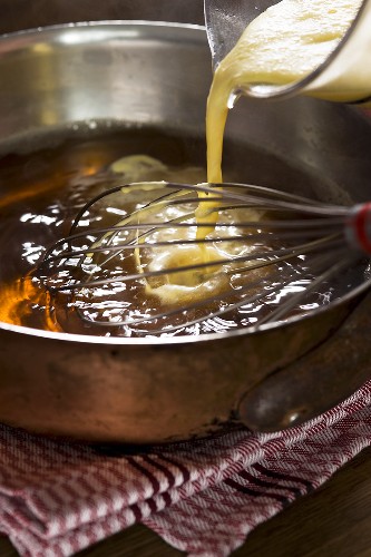 Wine soup - egg-cream mixture being stirred in