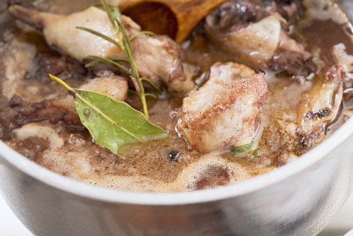 Duck sauce being prepared: bones and meat being simmered with spices