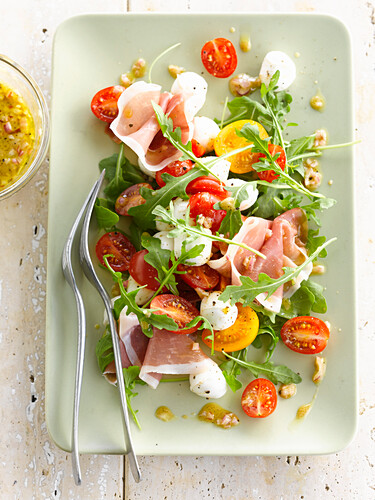 Rocket lettuce,cherry tomato,mozzarella and prosciutto salad