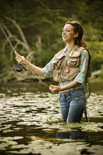 Woman Fly Fishing in River – License Images – 687511 ❘ StockFood