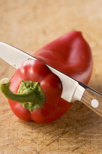 Stalk being removed from a pepper