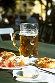 A litre of beer with pub lunch and pretzels