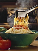 Bowl of Spaghetti with Tomato Sauce; Tongs