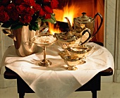 Silver Tea Set; Table in Front of Fireplace