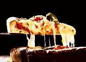 Lifting a Slice of Pizza with Melted Cheese