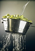 Rinsing Spinach Ribbon Pasta in a Colander