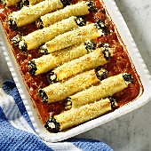 Spinach Canneloni on Tomato Sauce in a Baking Dish