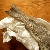 A piece of dried cod on paper