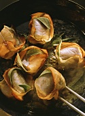 Eel tournedos wrapped in ham with sage in the pan