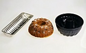 A fruit cake, black fruit cake- & silver rehrücken cake moulds