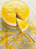 Cheesecake with lemon icing; & piece on cake slice