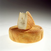 Wheel of Soft Cheese with a Wedge Taken Out