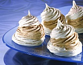 Meringues filled with mocha cream on glass plate