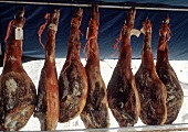 Several Spanish Hams Hanging in a Market