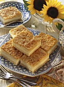 Several pieces of filled bee-sting cake; sunflowers