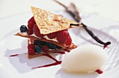 Champagne sorbet beside a small berry dessert