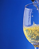 Sparkling wine effervescing as it is poured into a glass