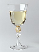 A filled white wine glass