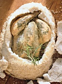 Whole herb chicken cooked in salt crust