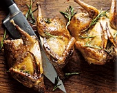 Grilled game birds seasoned with rosemary