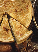 Apple cream tart (pastry with apples, cream topping & almonds)