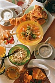 Brunch of potato and herb tortilla and filled croissants